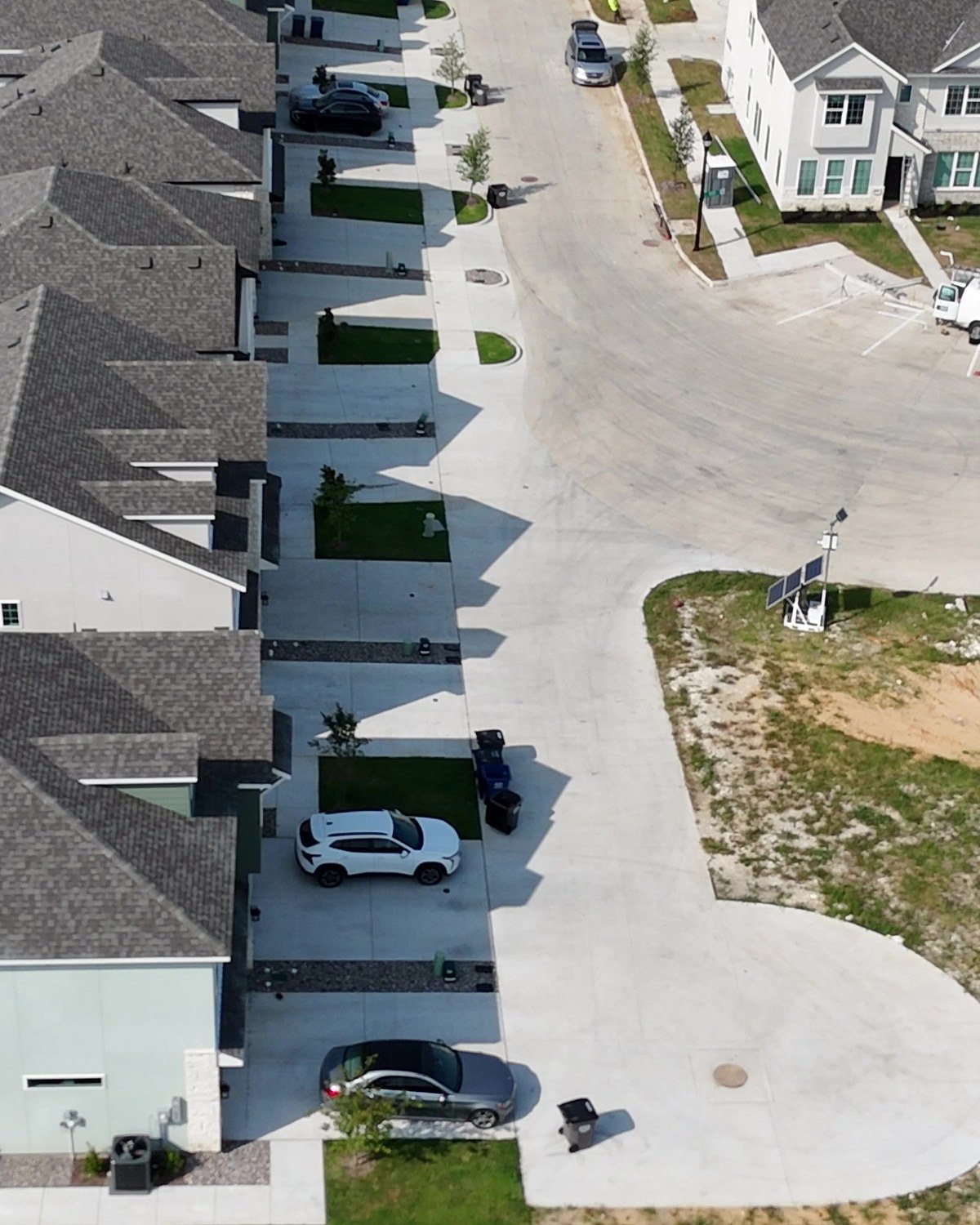 Sidewalks and driveways along a curved residential street in Red Oak, Texas