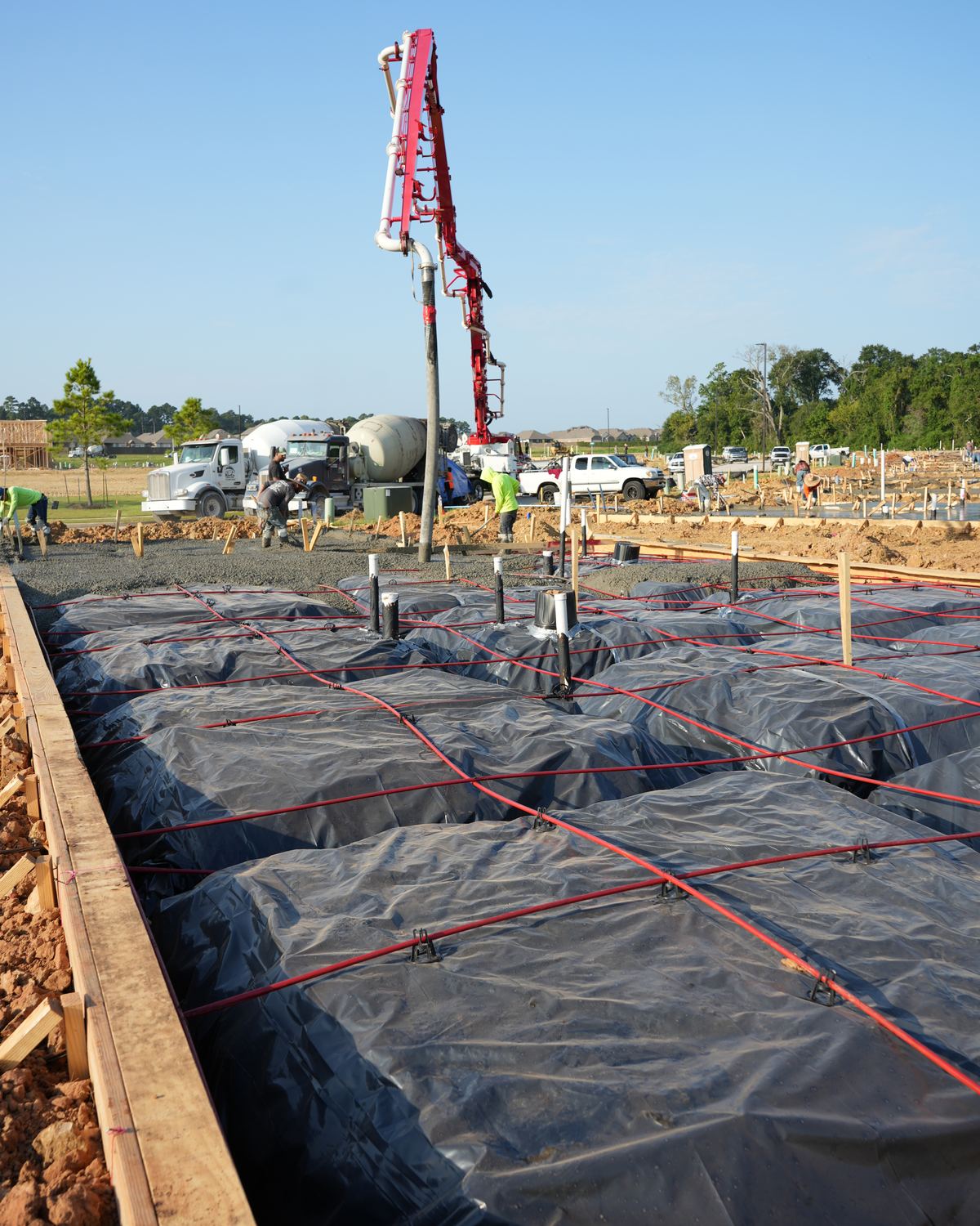 Vapor barrier and post-tension cable set inside the forms before a residential slab pour